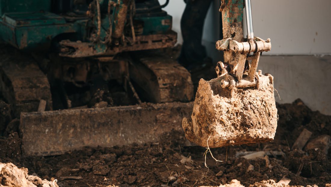 close up worker backhoe working in construction site close up worker backhoe working in construction site